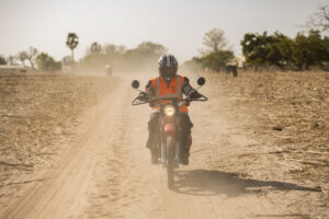 Motorcycle rider on dusty road